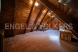 Discover this unique attic space, boasting a charming wooden interior and ample natural light.