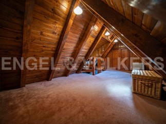 Discover this unique attic space, boasting a charming wooden interior and ample natural light.