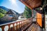 This stunning property boasts a picturesque balcony overlooking a charming village nestled in the mountains.