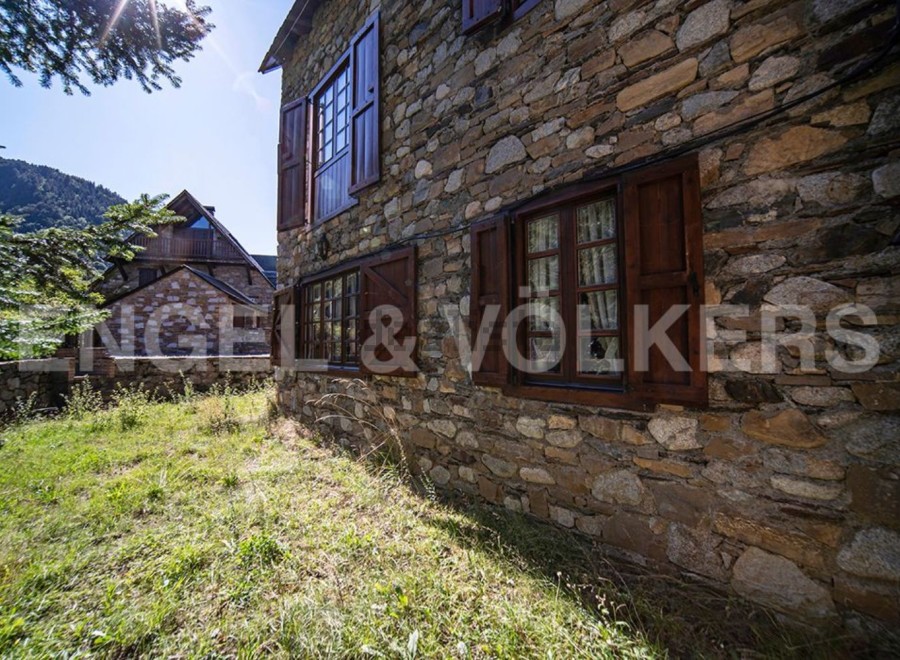 Rustic stone house nestled in the mountains, offering stunning views and tranquility.