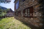 Rustic stone house nestled in the mountains, offering stunning views and tranquility.