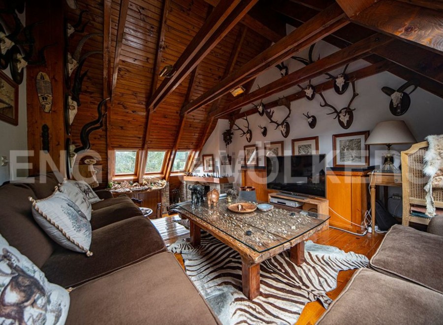 Rustic mountain chalet with stunning wooden beams and a cozy living area.