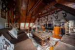 Rustic mountain chalet with stunning wooden beams and a cozy living area.