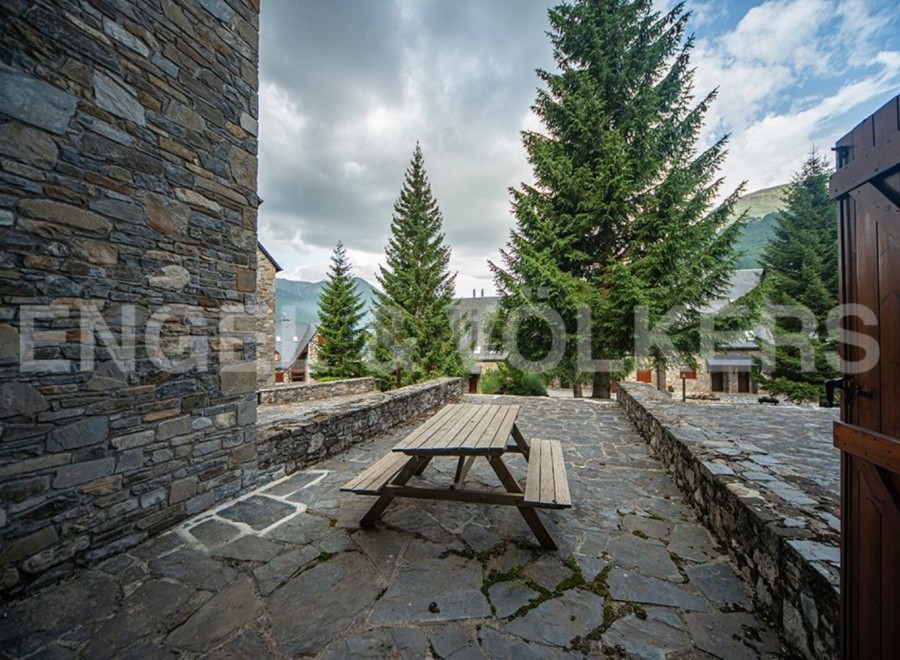 This charming stone property boasts a picturesque outdoor patio, perfect for enjoying the mountain views.