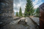 This charming stone property boasts a picturesque outdoor patio, perfect for enjoying the mountain views.