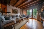 This stunning chalet boasts a spacious living area with large windows offering breathtaking views.
