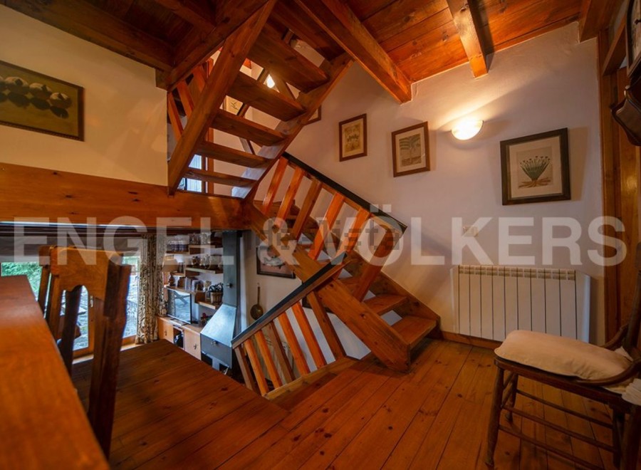 This charming property boasts a unique wooden staircase that is both functional and visually stunning.