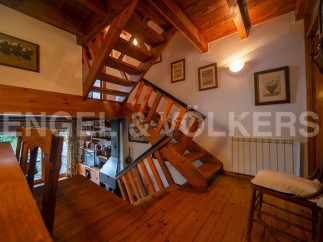 This charming property boasts a unique wooden staircase that is both functional and visually stunning.