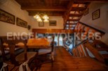 Charming wooden chalet with a spacious dining area and stunning wooden staircase.