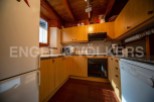 Cozy mountain kitchen with wooden cabinets and granite countertops.