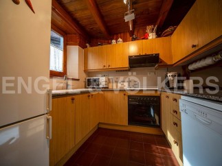 Cozy mountain kitchen with wooden cabinets and granite countertops.