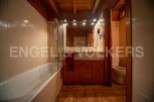 Charming bathroom with wooden finishes and a bathtub.