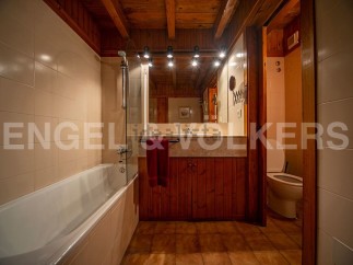 Charming bathroom with wooden finishes and a bathtub.