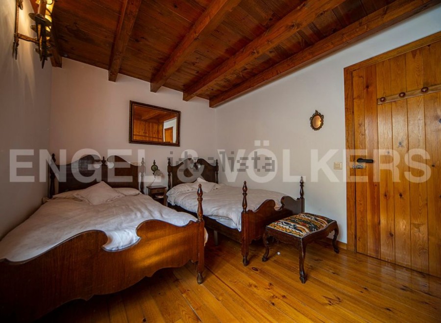 Charming rustic bedroom with twin beds and wooden floors.