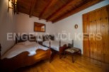 Charming rustic bedroom with twin beds and wooden floors.