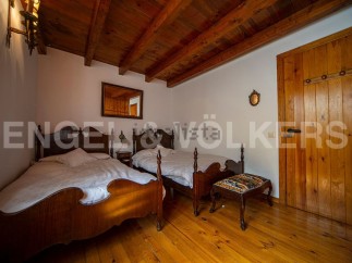 Charming rustic bedroom with twin beds and wooden floors.