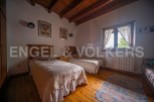 Charming bedroom with twin beds, wooden floors, and a rustic feel.