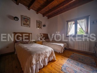 Charming bedroom with twin beds, wooden floors, and a rustic feel.