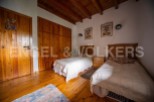 Charming bedroom with wooden floors and built-in wardrobe.