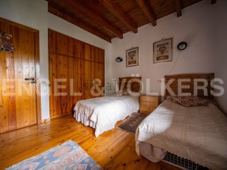 Charming bedroom with wooden floors and built-in wardrobe.
