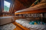 Cozy attic bedroom with wooden bunk beds, perfect for kids or guests.
