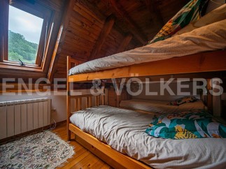 Cozy attic bedroom with wooden bunk beds, perfect for kids or guests.