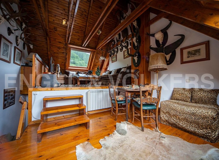 This unique property boasts a stunning wooden interior with a cozy attic space.