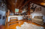 This unique property boasts a stunning wooden interior with a cozy attic space.