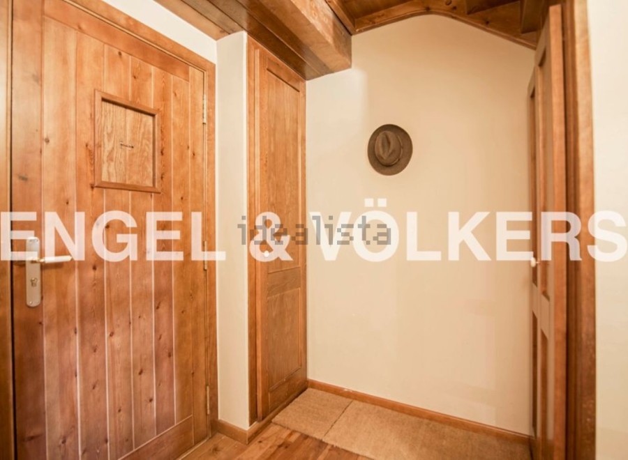 Charming wooden hallway with built-in storage and rustic details.