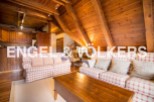 Cozy A-frame chalet with exposed wooden beams and a spacious living area.