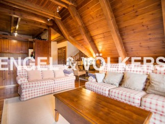 Cozy A-frame chalet with exposed wooden beams and a spacious living area.