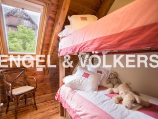 Charming wooden cabin with a cozy bunk bed, perfect for a family getaway.