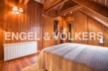 Cozy wooden bedroom with built-in wardrobes and a warm atmosphere.