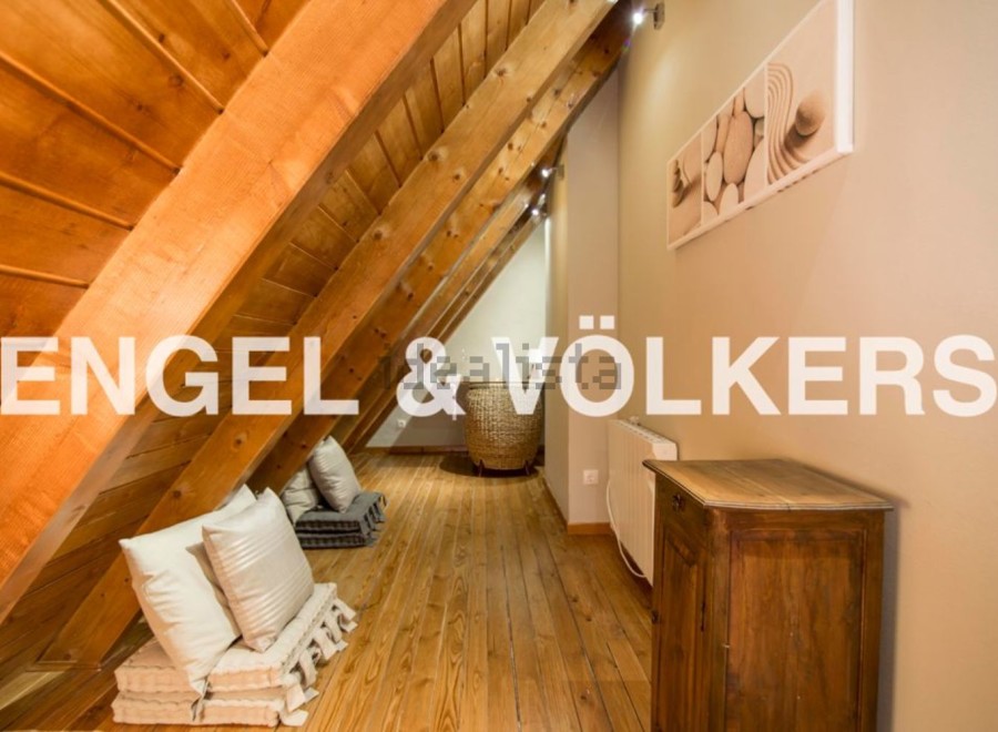 Charming attic space with wooden beams and floors, offering a cozy and unique atmosphere.