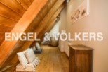 Charming attic space with wooden beams and floors, offering a cozy and unique atmosphere.