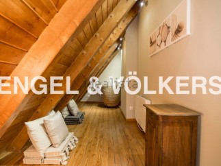 Charming attic space with wooden beams and floors, offering a cozy and unique atmosphere.