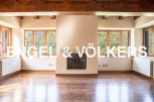 Spectacular mountain views fill this open-concept living space, featuring hardwood floors and a cozy fireplace.