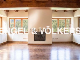 Spectacular mountain views fill this open-concept living space, featuring hardwood floors and a cozy fireplace.