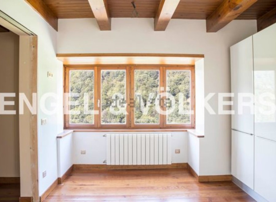 This stunning property boasts a spacious and bright interior with large windows offering breathtaking views.