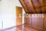 Charming attic room with wooden beams and built-in wardrobes.