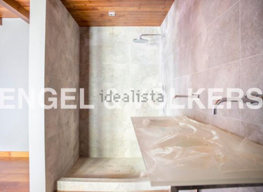 Modern bathroom with a walk-in shower and sleek countertops.