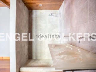 Modern bathroom with a walk-in shower and sleek countertops.