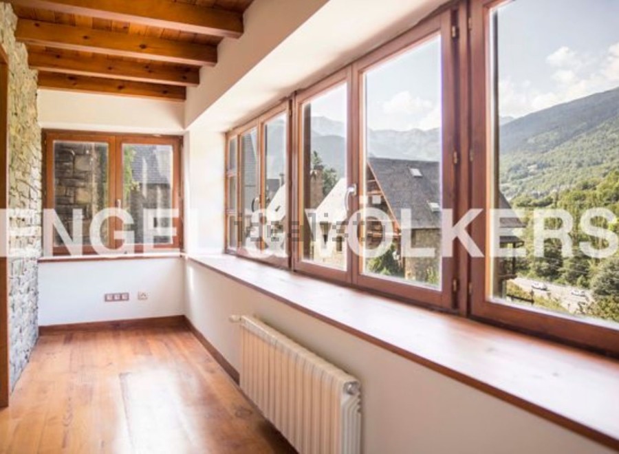 This stunning property boasts a spacious sunroom with large windows offering breathtaking mountain views.
