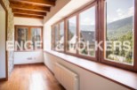 This stunning property boasts a spacious sunroom with large windows offering breathtaking mountain views.