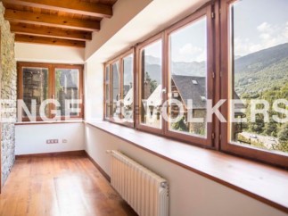 This stunning property boasts a spacious sunroom with large windows offering breathtaking mountain views.