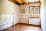 Charming bedroom with wooden beams and hardwood floors.