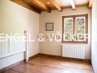 Charming bedroom with wooden beams and hardwood floors.