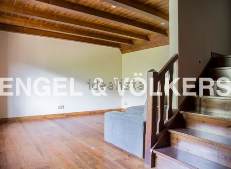This stunning property boasts a spacious open-plan living area with gleaming hardwood floors and a charming wooden beamed ceiling.