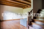 This stunning property boasts a spacious open-plan living area with gleaming hardwood floors and a charming wooden beamed ceiling.