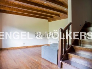 This stunning property boasts a spacious open-plan living area with gleaming hardwood floors and a charming wooden beamed ceiling.